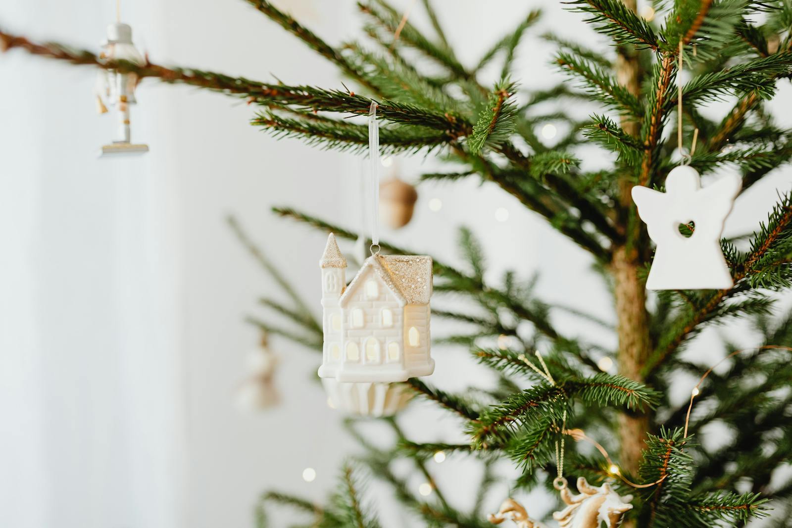 Close-up of elegant holiday ornaments on a Christmas tree branch, perfect for festive decor themes.